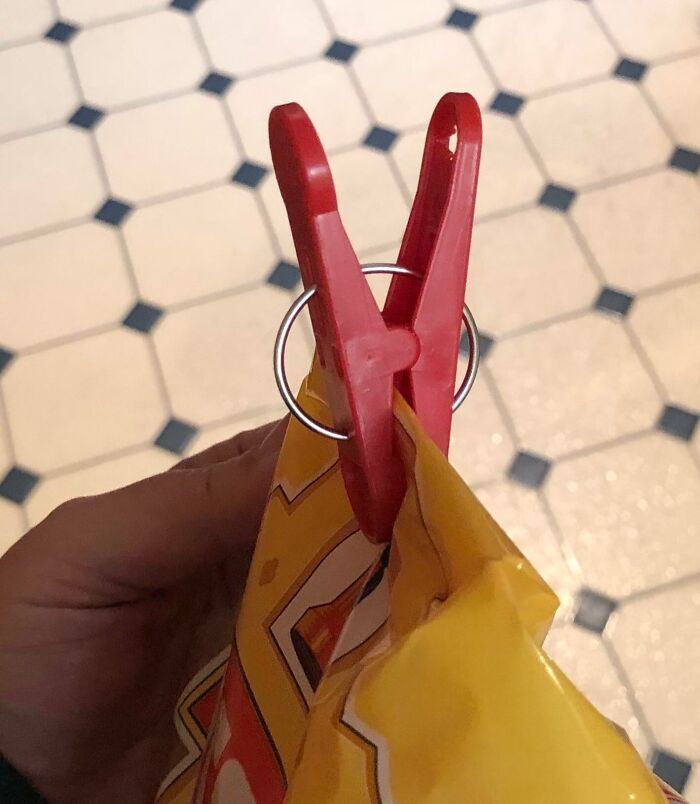 A red clothespin sealing a snack bag as a grocery-shopping-hack.