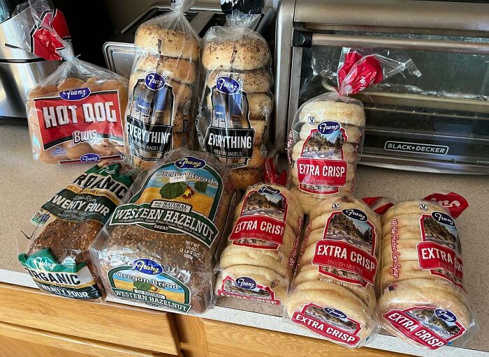 Assorted bread varieties on a kitchen counter showcasing grocery shopping hacks for buying in bulk.