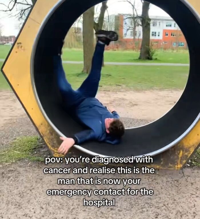 Man awkwardly falling inside a large circular structure in a park, representing an emergency crisis situation.