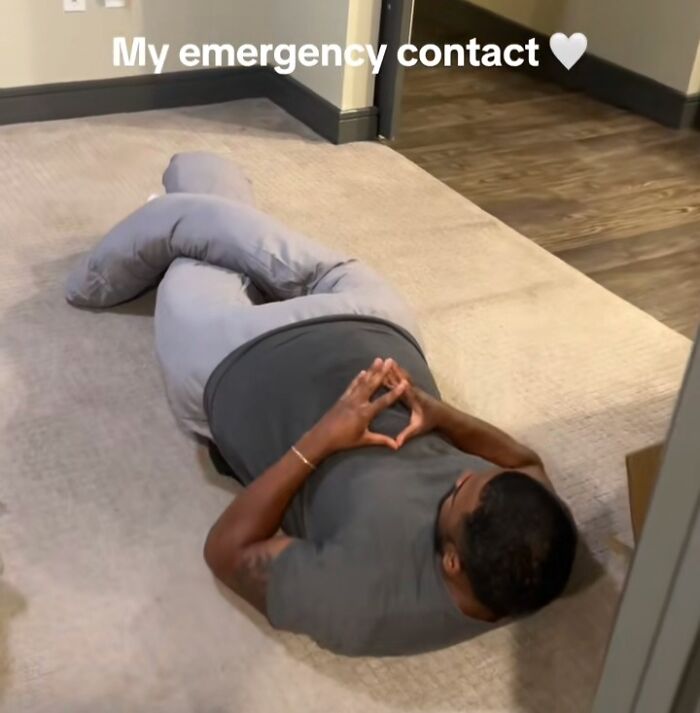 Man lying on the floor, forming a heart shape with hands, symbolizing crisis in handling emergencies.