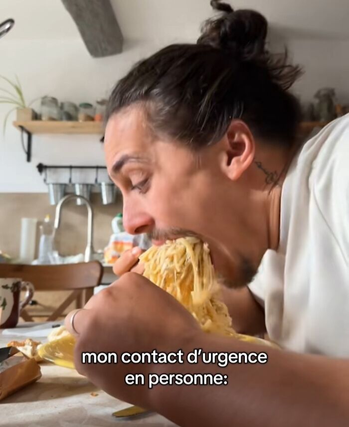 Man with long hair eating spaghetti humorously, labeled as an emergency contact.