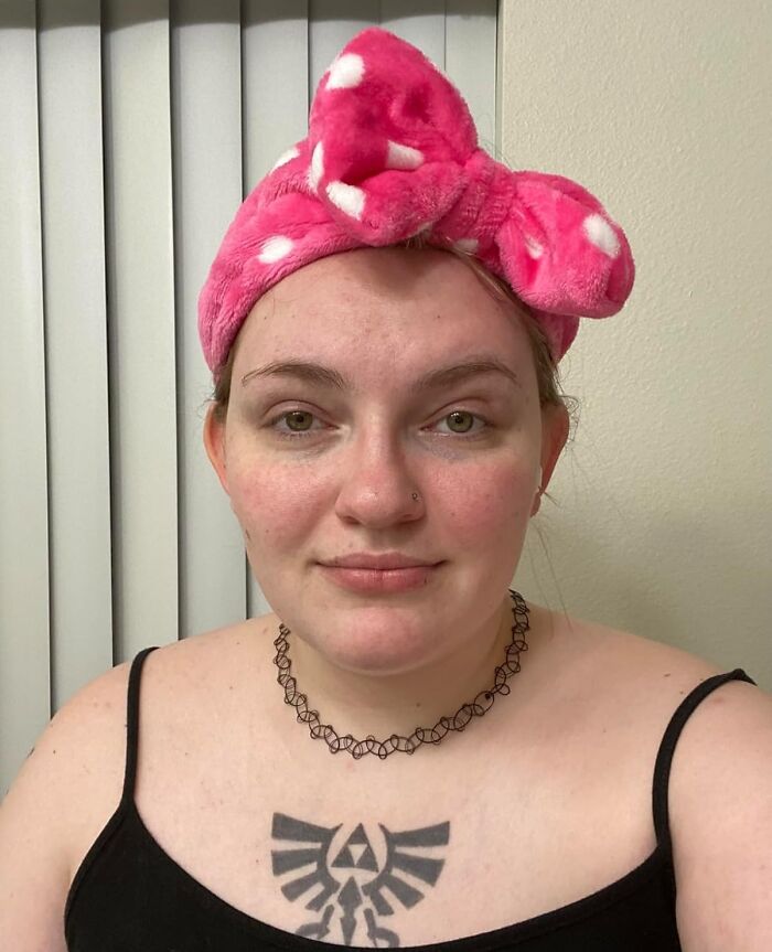 Young woman wearing a pink polka dot headband and black tank top, demonstrating affordable beauty items under five dollars.