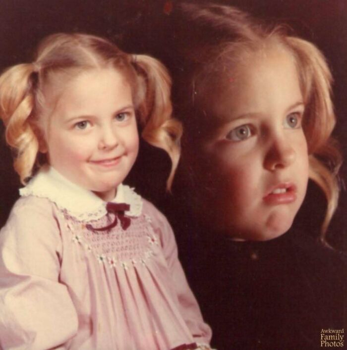Young girl with pigtails posing for an awkward family photo with a double image effect, capturing a sweet and nostalgic moment.