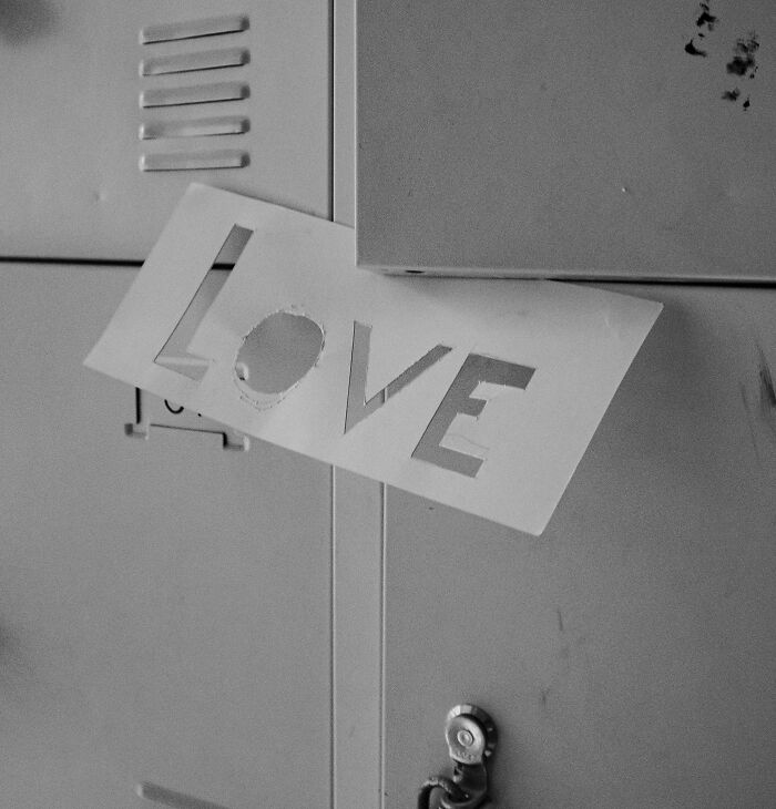 "Paper with cut-out letters spelling LOVE on a locker, showcasing eye-opening moments."