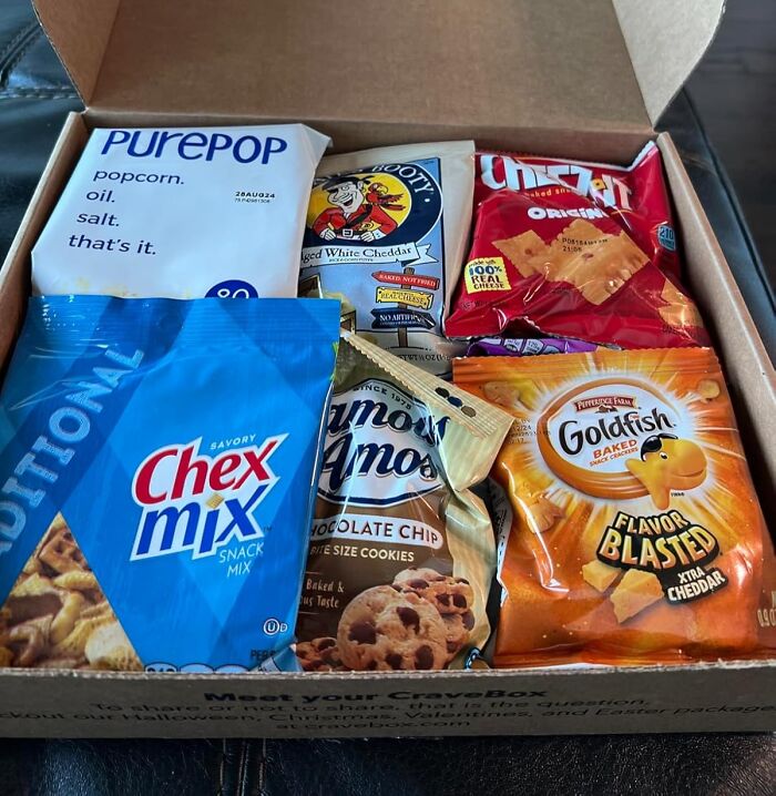Snack box with popcorn, Chex Mix, cookies, chips, and Goldfish crackers for fun date night ideas that actually slap.