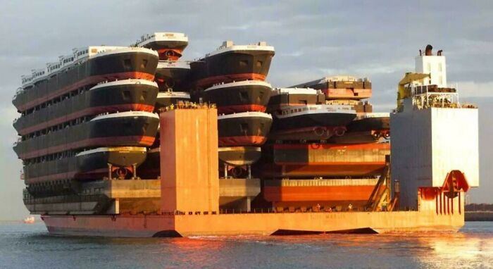 Massive ship transport carrying multiple large vessels stacked, showcasing a scarily big example of megalophobia.