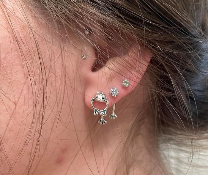Weird things: unique ear piercings with artistic silver and gem earrings.