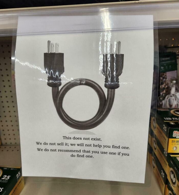 Funny sign with a diagram of a plug and text humorously disclaiming its existence and sale.