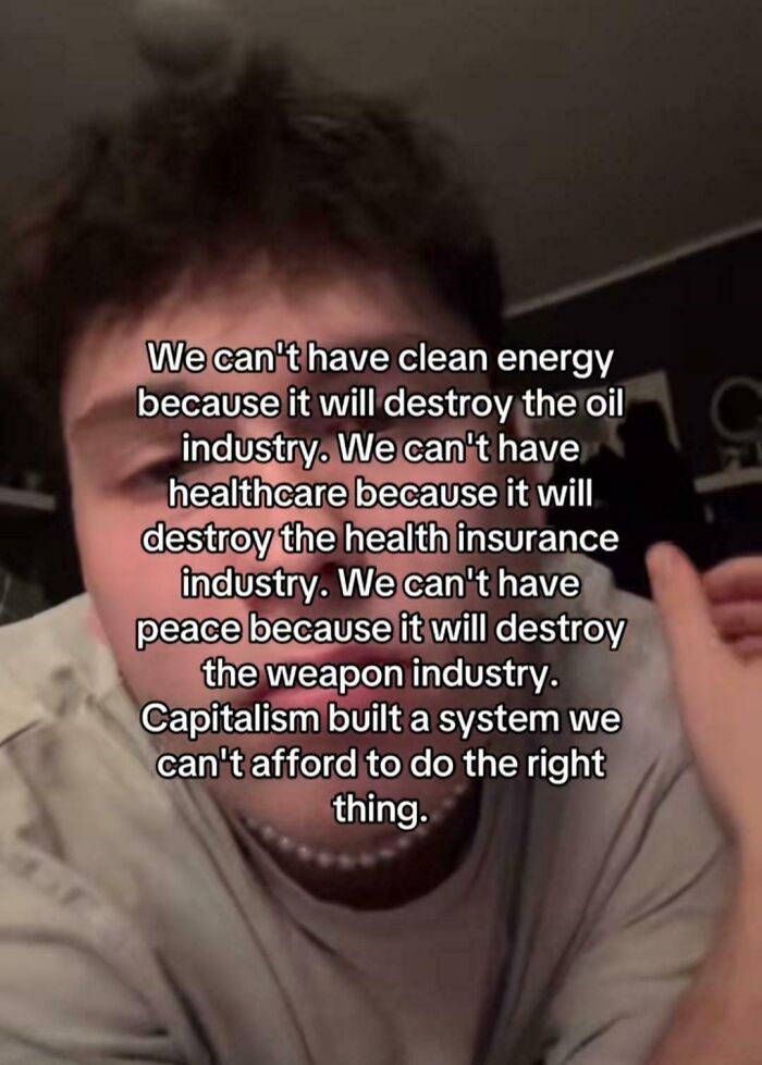 A person expressing a critical message about consumerism and capitalism, highlighting its ironic and sad effects.