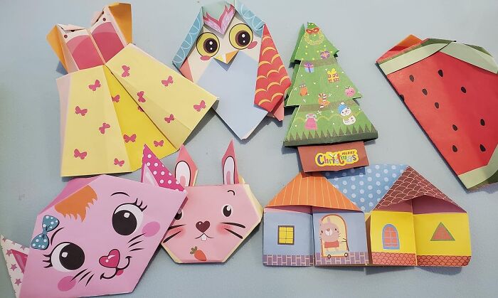 Artistic finds: colorful origami animals, Christmas tree, and watermelon designs on a light blue background.