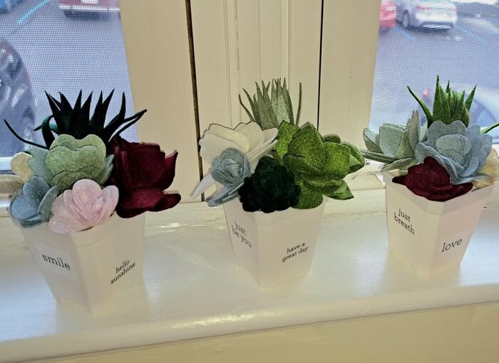 Decorative felt flowers in pots with inspirational text, enhancing your creative spirit with artistic finds.