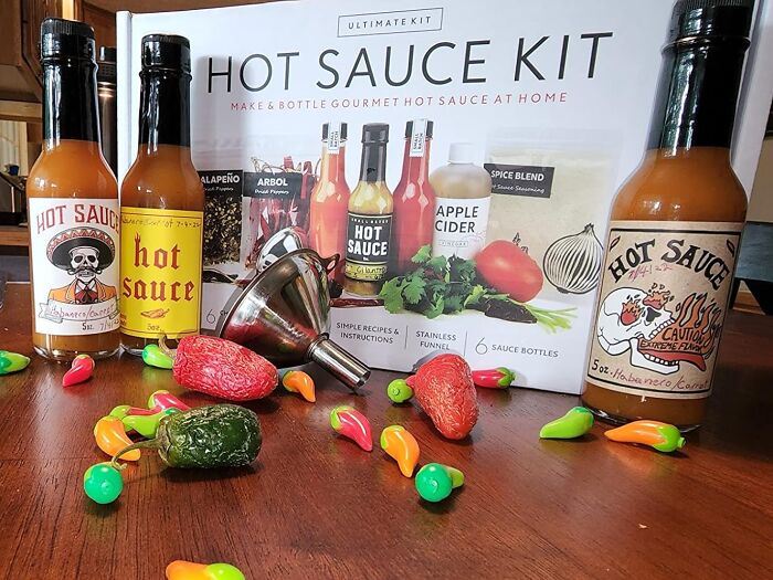 Hot sauce kit with vibrant peppers and fun packaging, appealing to your creative spirit in culinary adventures.