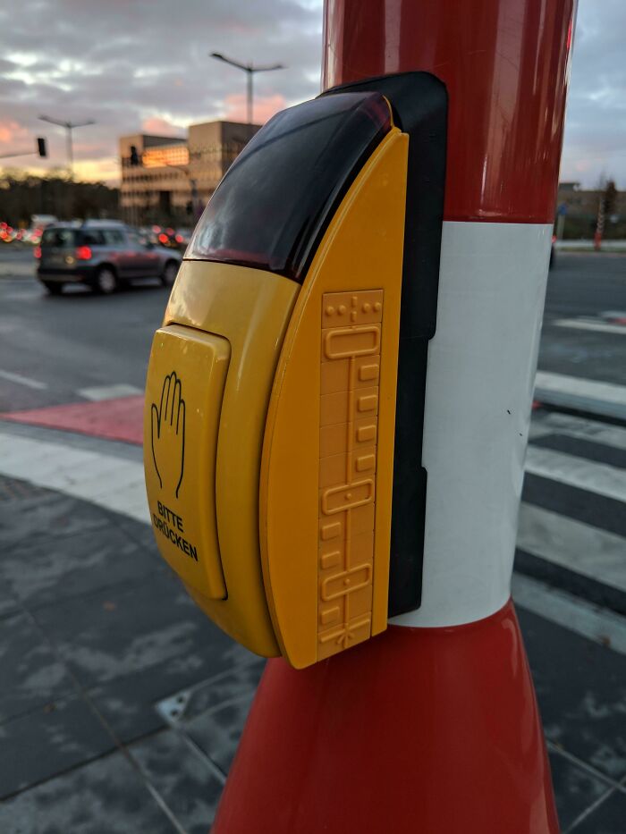 Traffic button at a crosswalk, illustrating cities' genius solutions for pedestrian safety.