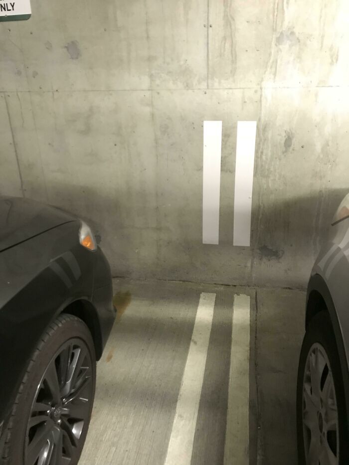 Parking lines misaligned against a wall; Cities-Genius-Solutions illustrate this as an urban design flaw.
