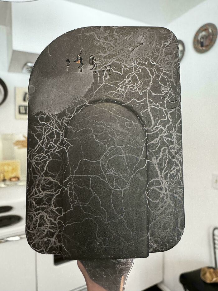 Spatula with intricate patterns from wear and tear, showcasing moderately interesting textures to share with the world.