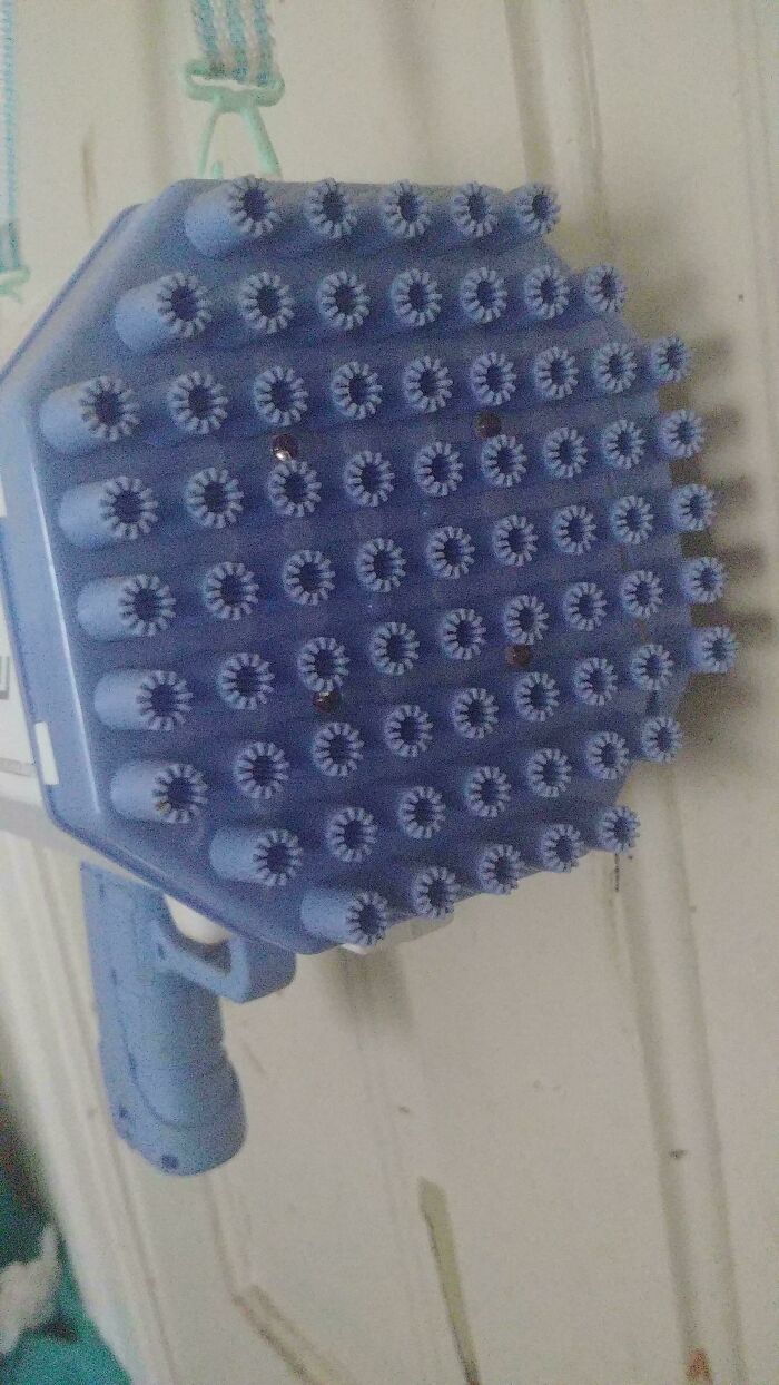 Blue brush with many small bristles, showcasing a unique and moderately interesting design shared with the world.