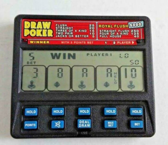'90s electronic draw poker game, displaying a winning hand, with buttons for holding and drawing cards.