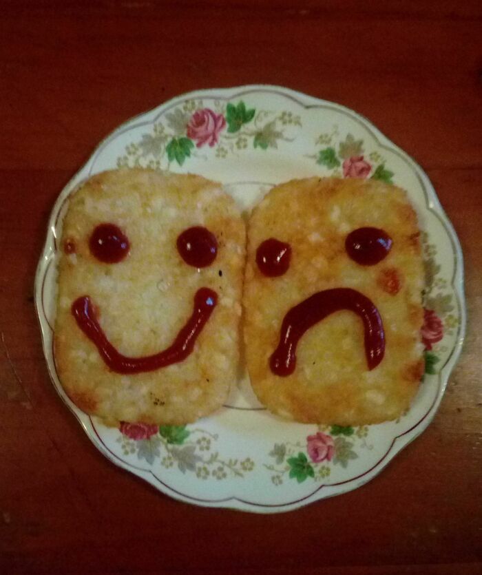 Hash browns with ketchup faces on a floral plate, illustrating budget-wedding-fails.