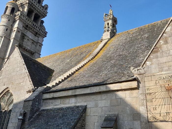 Steep stone stairs on a church roof under blue sky, often called "death stairs" for their daunting ascent.