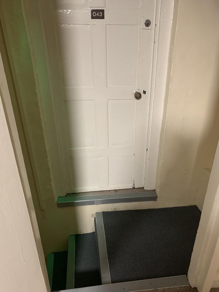 Narrow stairs leading to a door labeled D43, highlighting the concept of "death stairs."