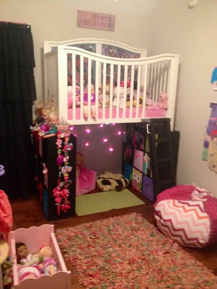 Children's loft bed with play area underneath, featuring a small ladder.