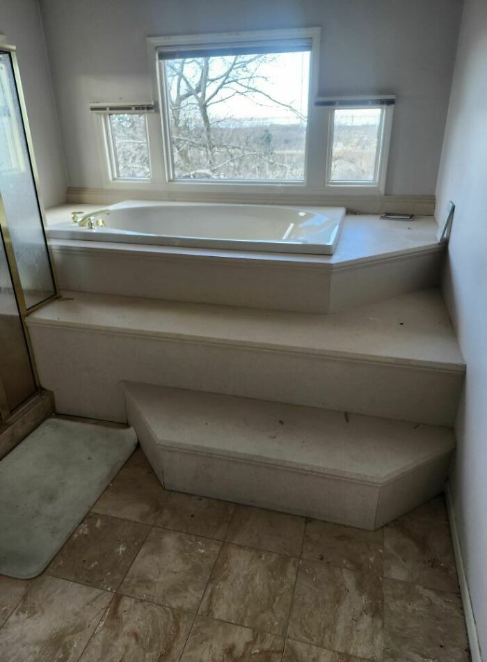 Steps leading up to a bathtub with a view, showcasing potential "death stairs" concept in a bathroom setting.