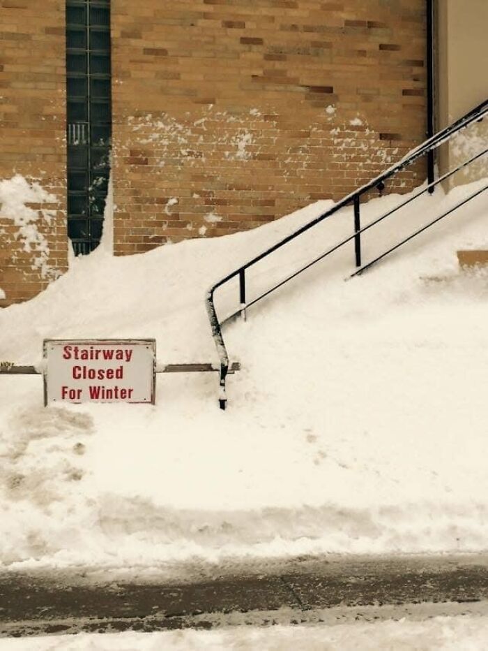 Snow-covered stairs with a "Stairway Closed For Winter" sign, illustrating the concept of "death stairs."