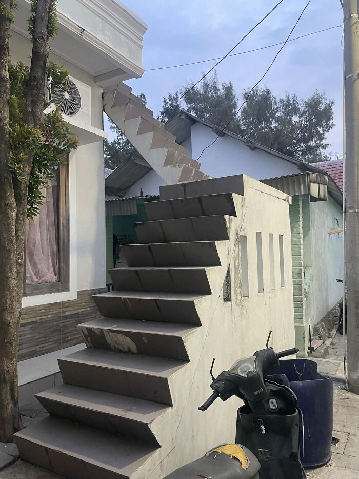 Unfinished and hazardous stairs leading to a roof, illustrating the concept of "death stairs" in an outdoor setting.