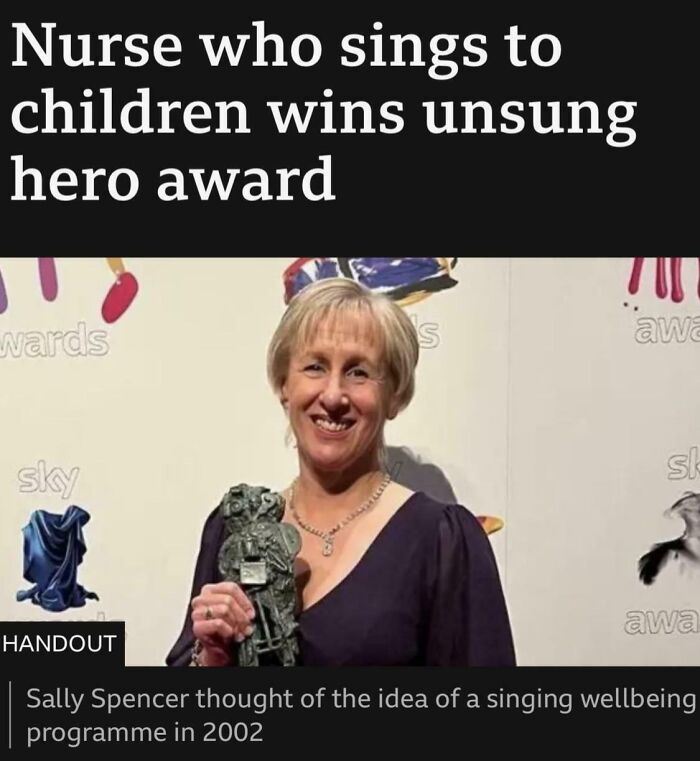 A nurse holding an award, smiling with a backdrop of colorful signage, related to hilarious news headlines.