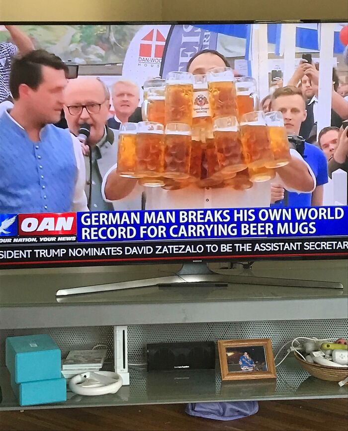 Man breaks record carrying beer mugs, featured on TV; an example of hilarious news headlines.
