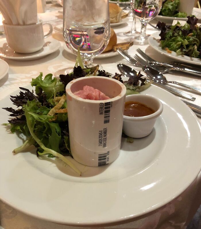 PVC pipe as a food container with salad and sauce at a budget wedding display.