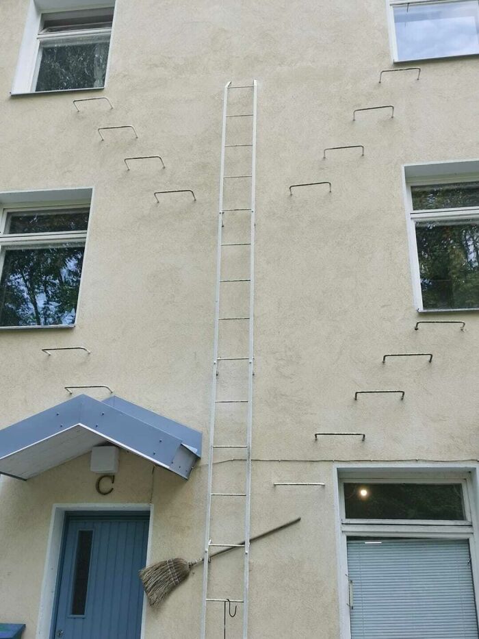 Ladder-like "death stairs" on building facade lacking proper steps, emphasizing risky design.
