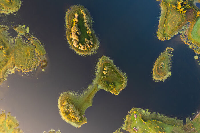 Aerial view of Lithuania's picturesque islands with lush greenery surrounded by water.
