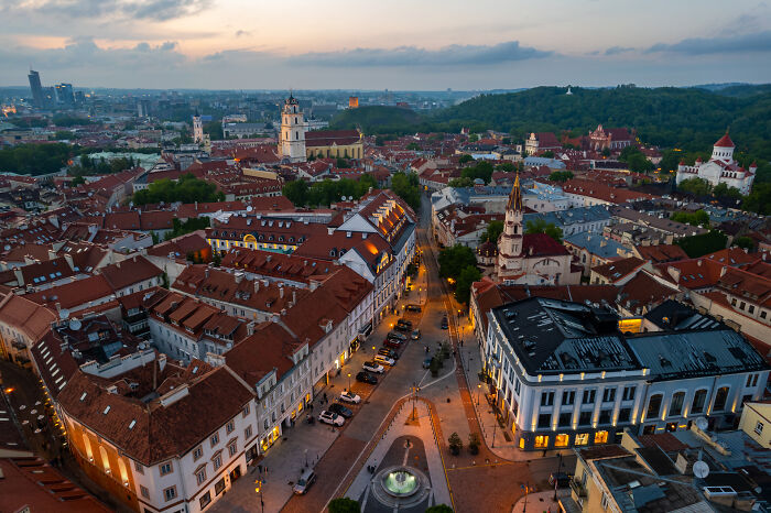 Aerial view of historic buildings and streets in Vilnius at dusk, showcasing the beautiful views of Lithuania.