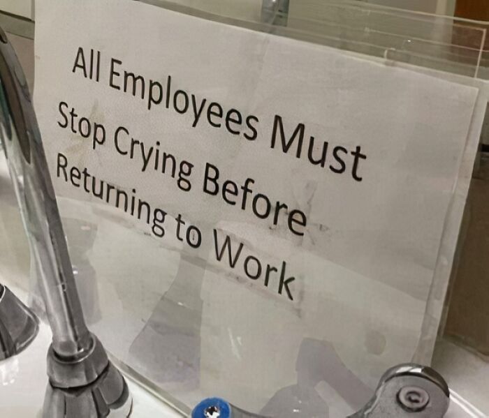 Sign reads, "All Employees Must Stop Crying Before Returning to Work," creating a hilarious scene with faucets nearby.