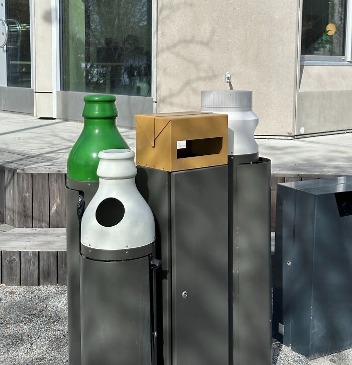 Innovative recycling bins in an urban setting, part of Cities-Genius-Solutions initiative for improved waste management.