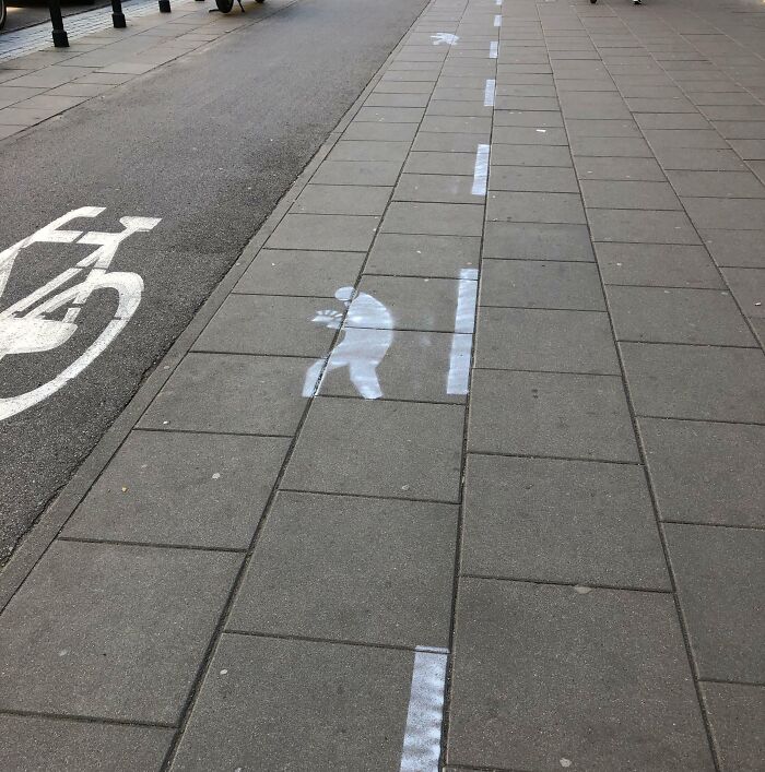 Sidewalk markings showing pedestrian lanes, a Cities-Genius-Solutions idea for organizing walking and cycling traffic.