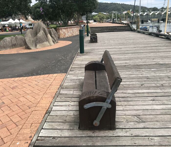 Park bench positioned on the edge of a boardwalk, showing Cities-Genius-Solutions in urban planning design.