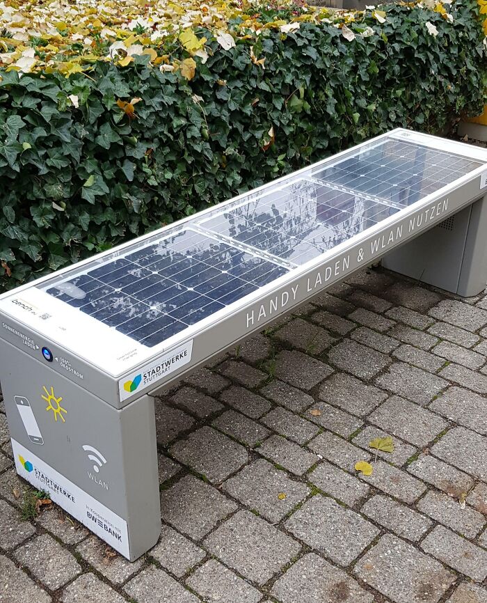 Solar-powered bench with charging ports and Wi-Fi, showcasing Cities-Genius-Solutions in urban design.