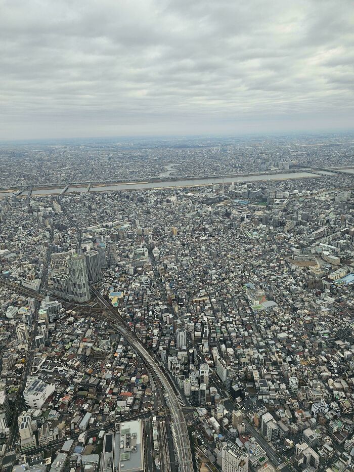 Overcast aerial view of an expansive urban landscape showcasing dense city infrastructure.