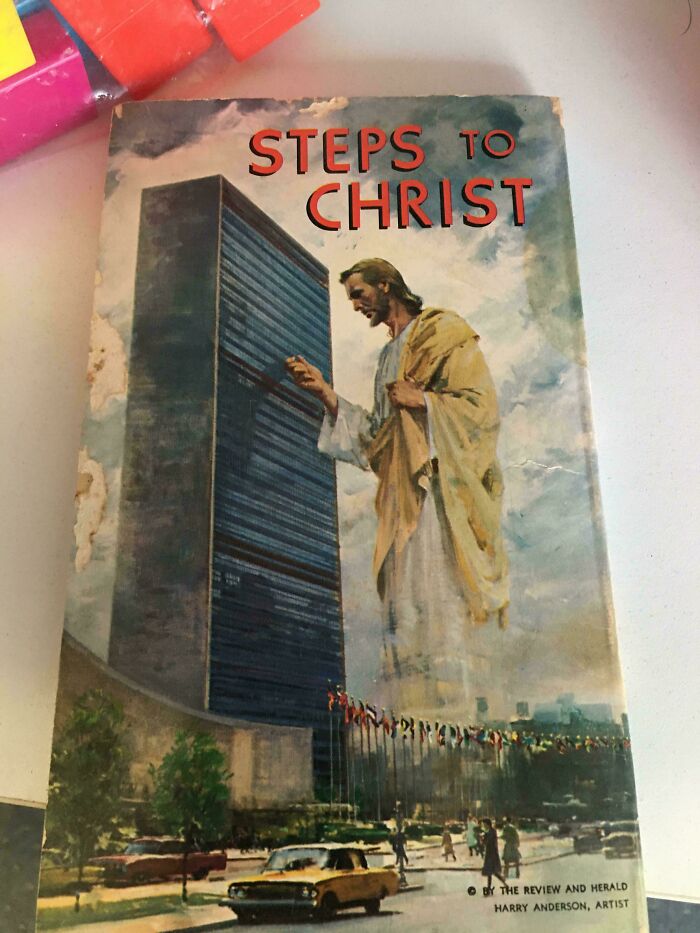 Terrible book cover depicting a large religious figure alongside a skyscraper.