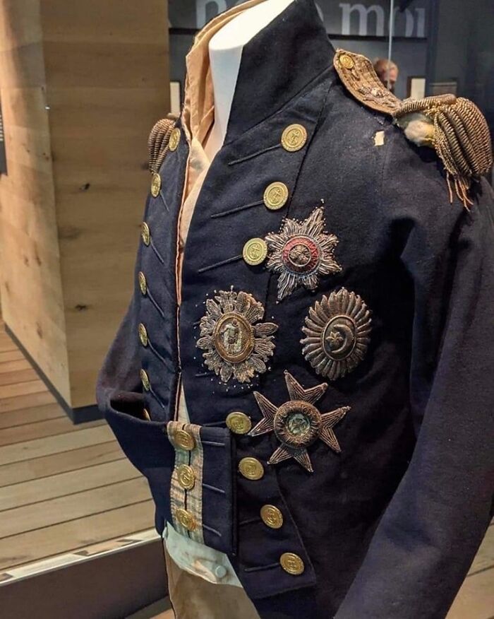 Historic military jacket adorned with intricate medals and gold buttons.