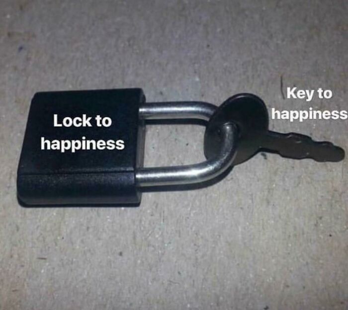 Lock labeled "lock to happiness" with key labeled "key to happiness" humorously depicting existential themes.