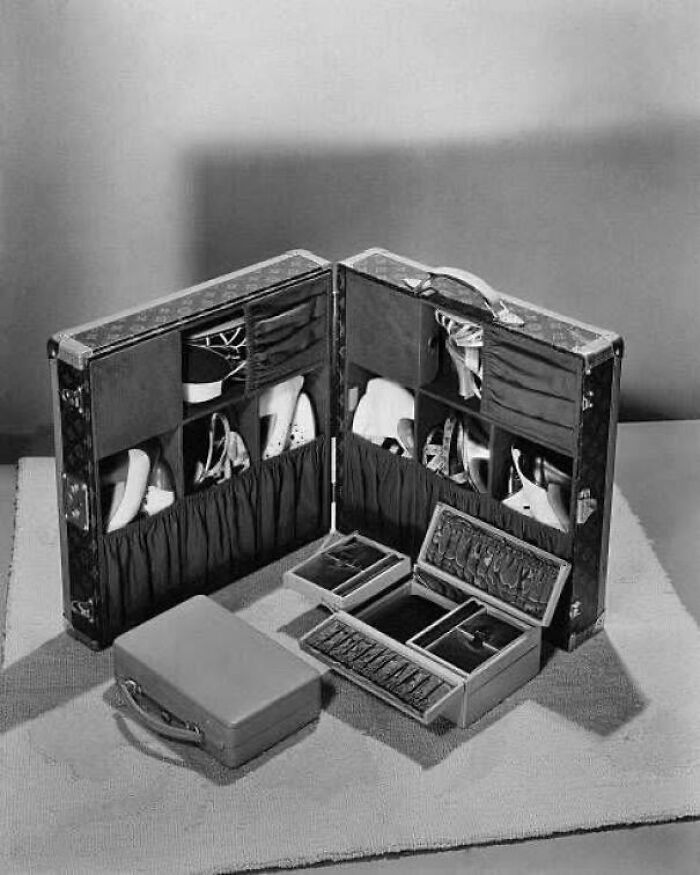 A vintage suitcase showcasing neatly organized shoes and accessories, presenting an interesting and unique travel storage solution.