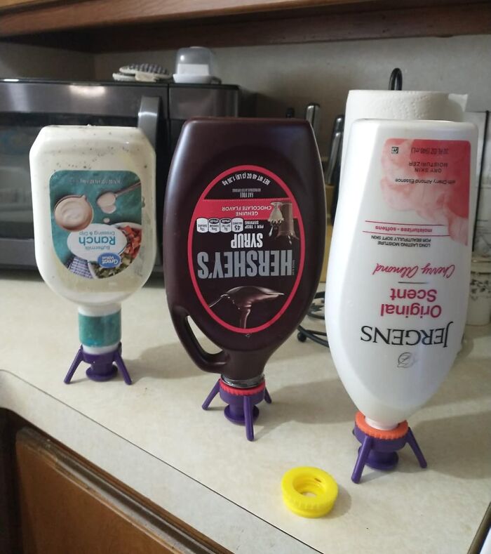 Kitchen bottles upside down on holders, a clever Amazon find to solve everyday dispensing problems.