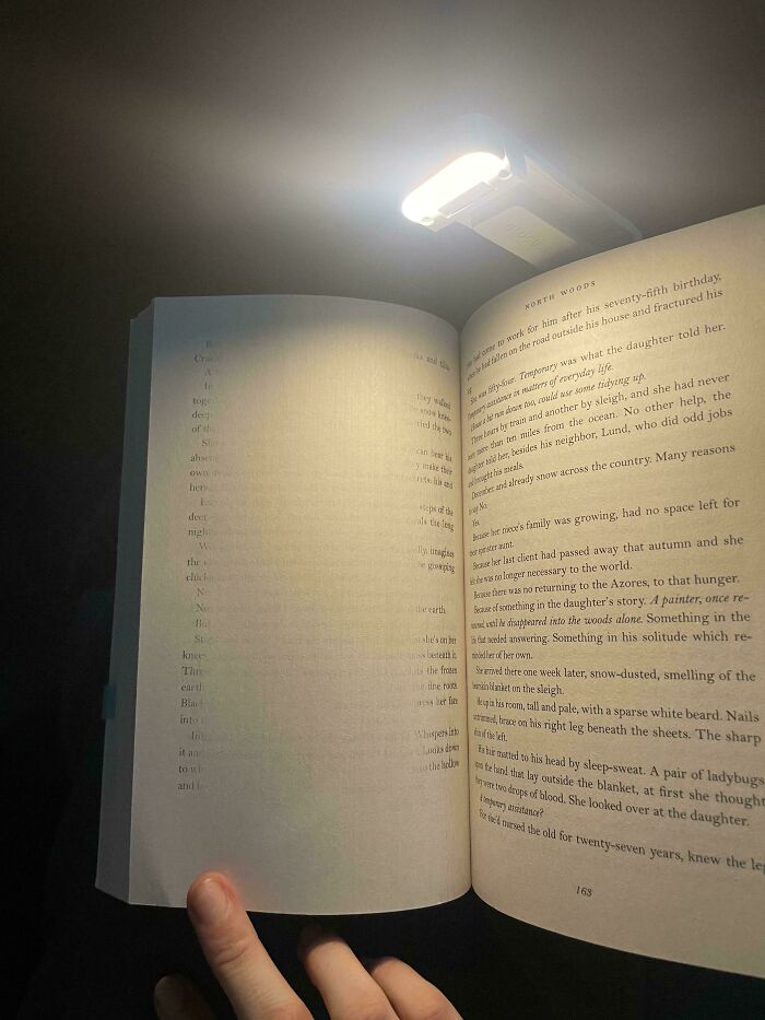 Open book under a reading light, representing poorly written designed books.