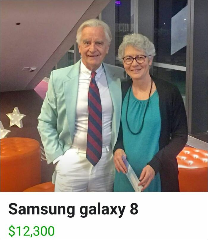 Elderly couple posing at an event, mistakenly listing Samsung Galaxy 8 for $12,300, showcasing Boomers' social media fails.
