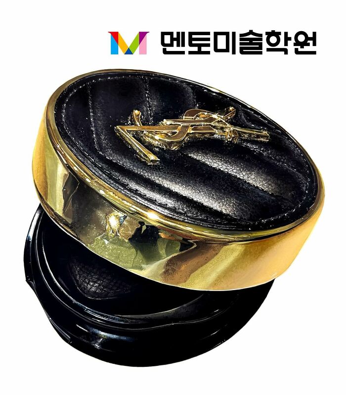 Hyperrealistic painting of a designer belt buckle with a black and gold design, showcasing realistic detail.