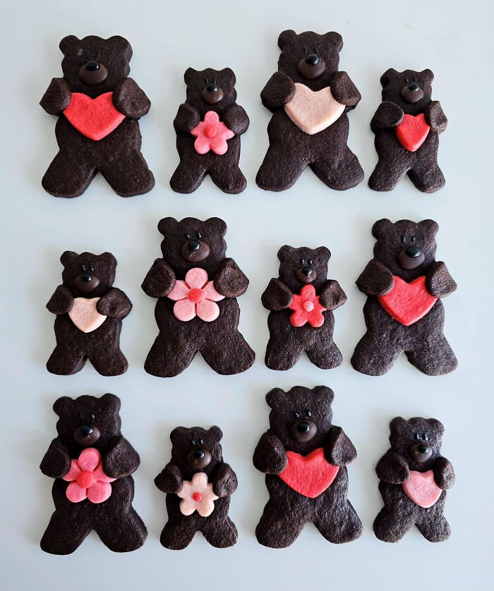 Chocolate bear cookies with pink and red heart and flower decorations, an example of incredible bakes for dessert lovers.