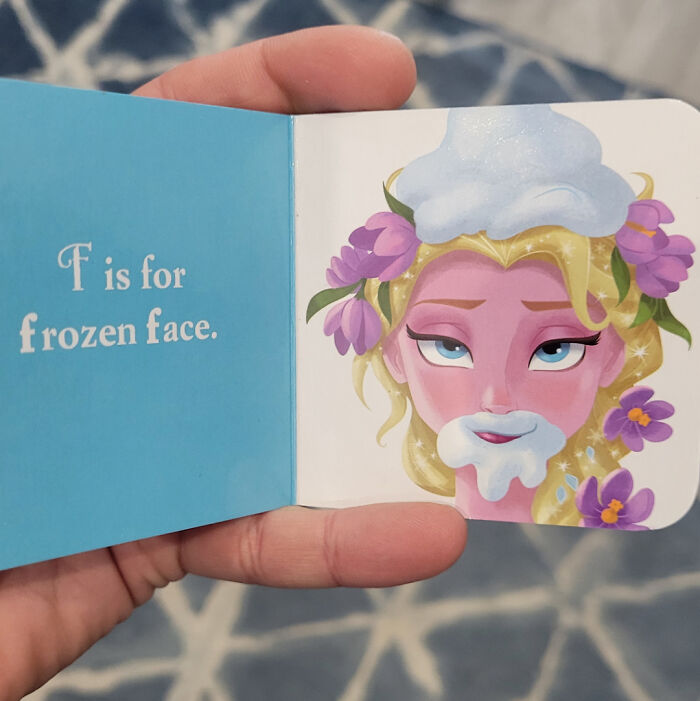 Open children’s book with "F is for frozen face" and a cartoon character, representing poorly written designed books.